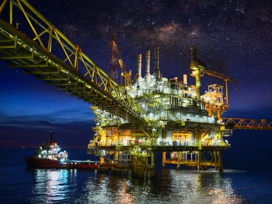 oil rig illuminated at night